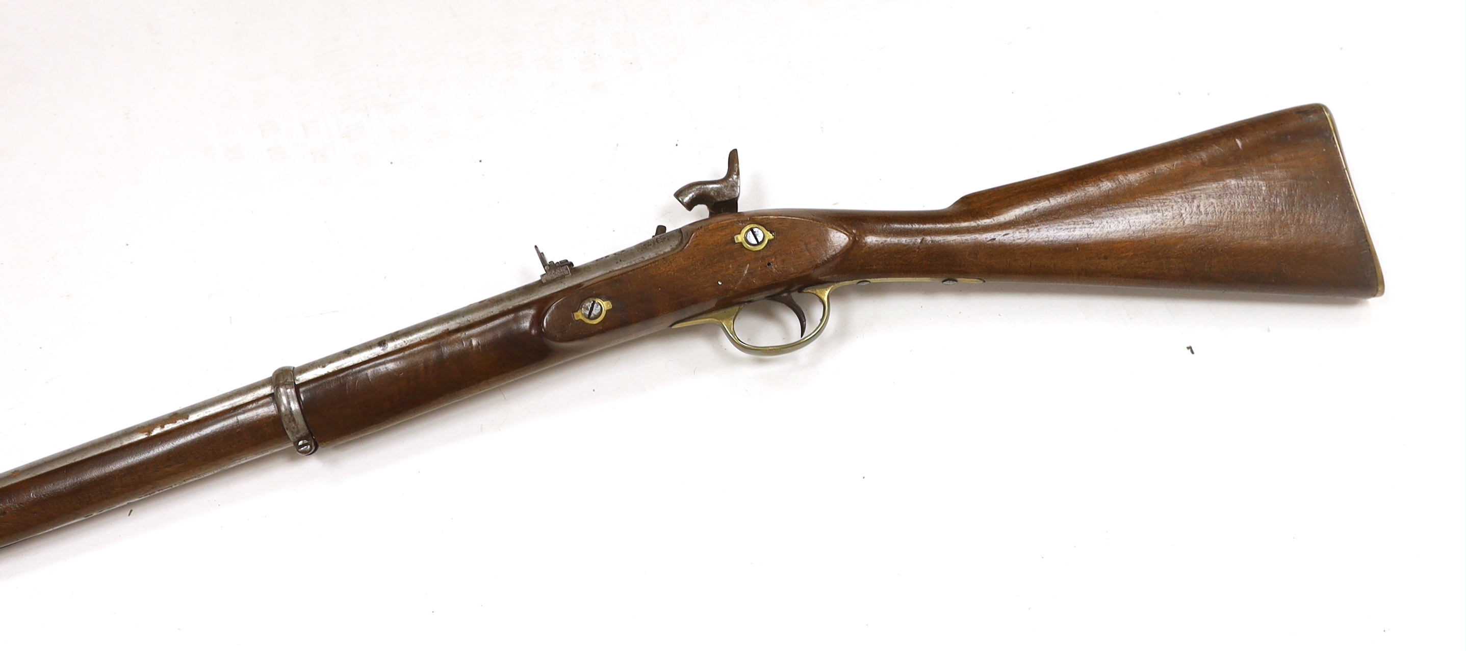 A two band percussion Military carbine of Indian use, regulation brass mounts, fold leaf rear sight, regulation brass mount, lock with Indian marks and also crowned VR, barrel 66.2cm
